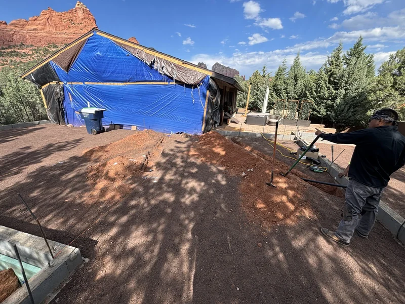 Roof framing tarped during the early demo and framing phase