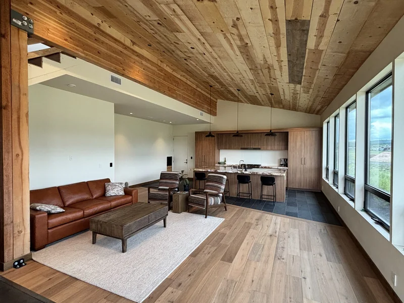 Finished great room with vaulted wood ceiling and kitchen island