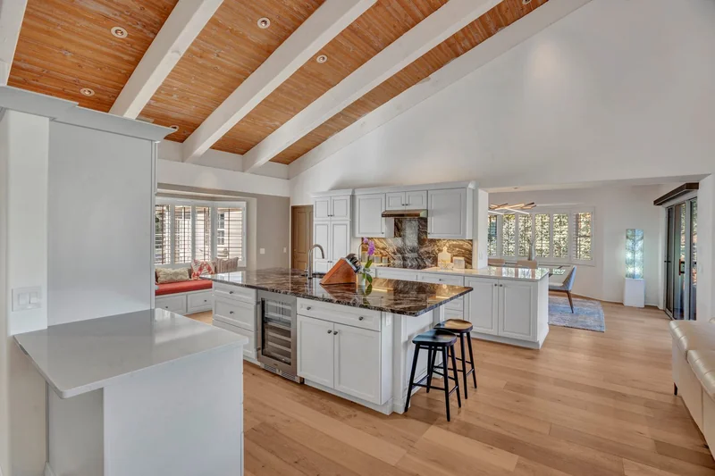 Updated kitchen with white cabinetry and stainless appliances