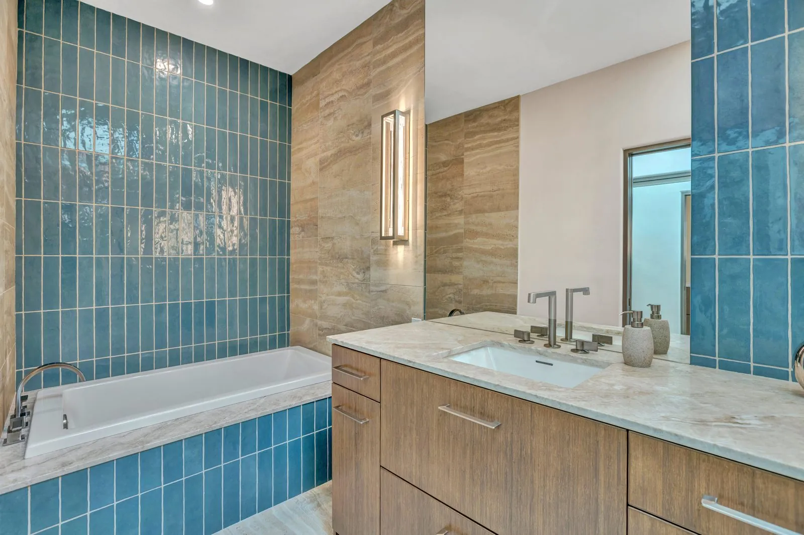Luxury primary bathroom with blue tile sauna shower and freestanding tub in Sedona