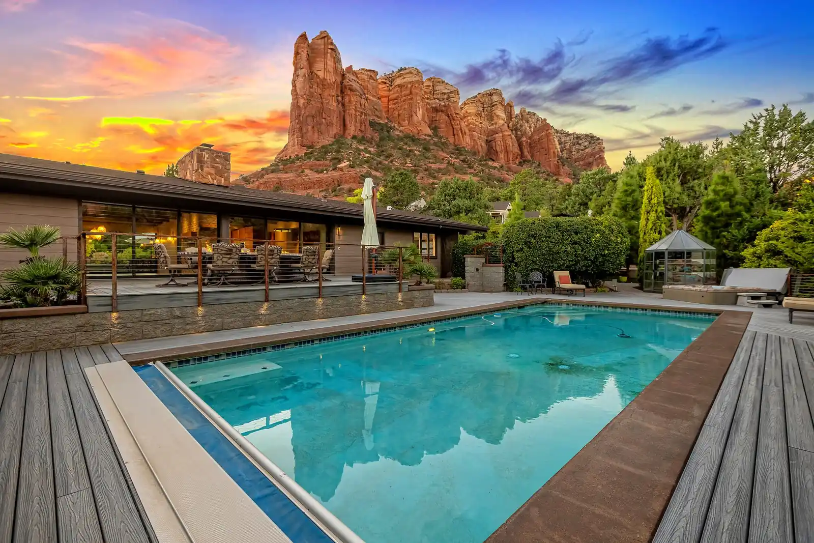 Sedona property at sunset with red rock backdrop and pool