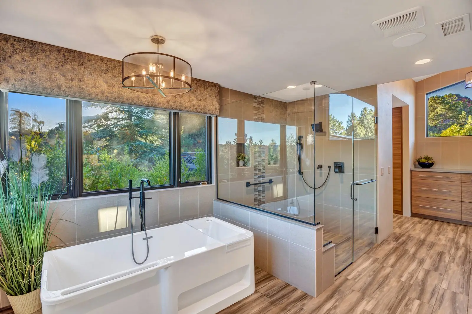 Primary bathroom layout with soaking tub, walk-in shower, and picture windows