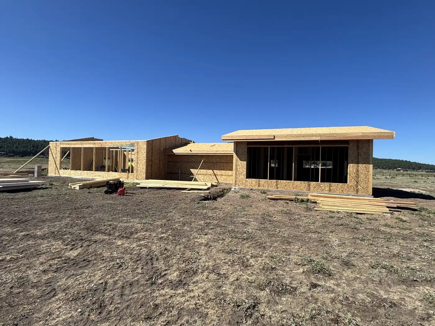 New construction framing under clear blue sky