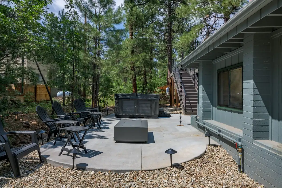 Ground level concrete patio with hot tub and seating in Munds Park